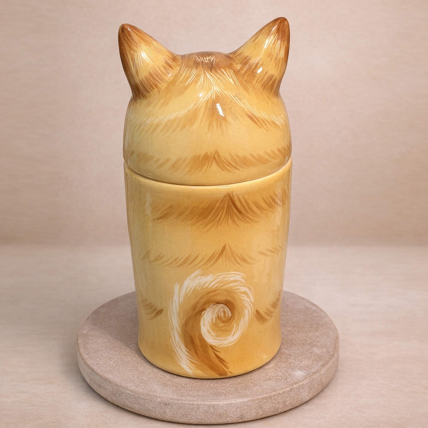 Handcrafted ceramic pet urn back view showing hand-painted tail detail